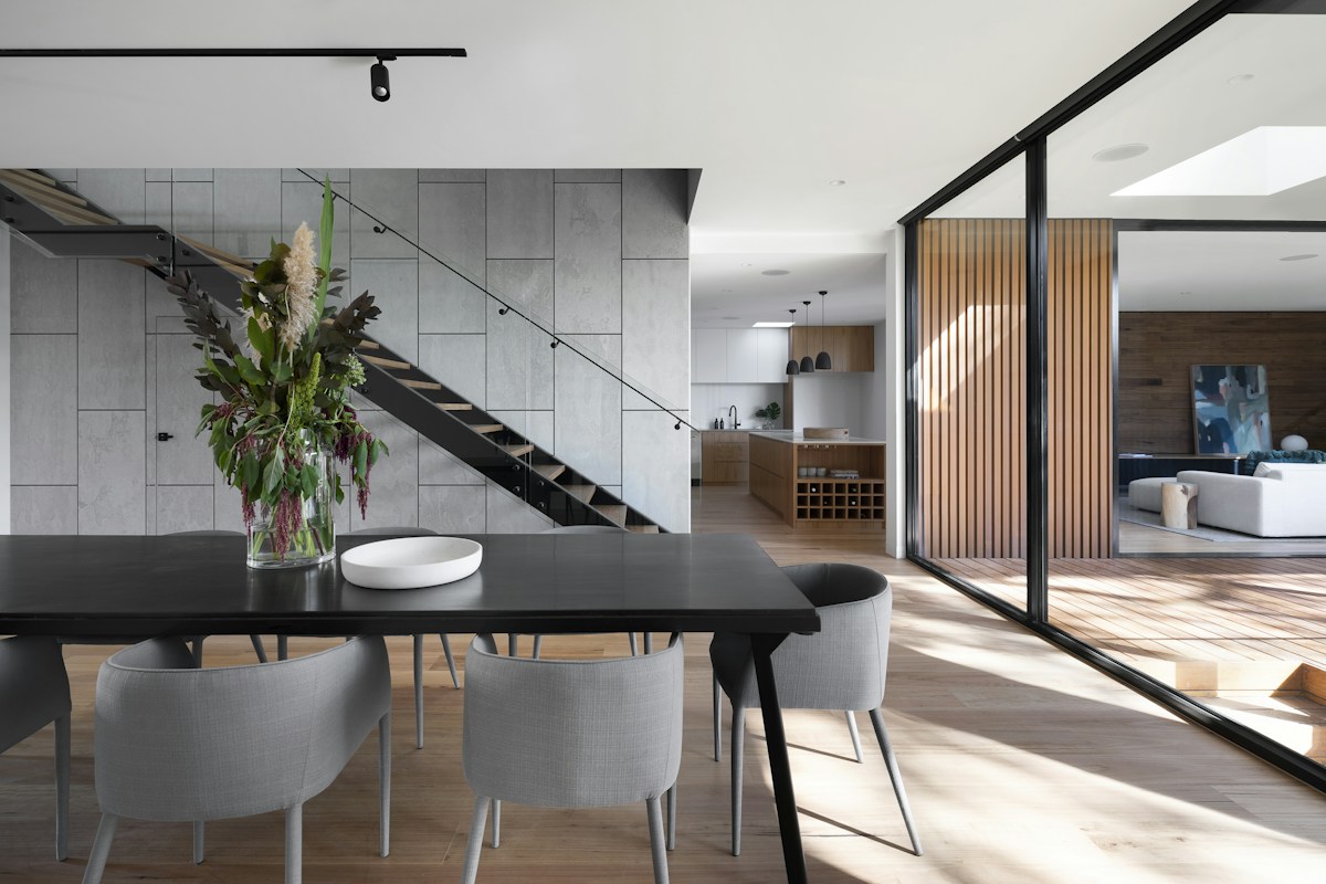 Contemporary dining and living space with warm timber finishes