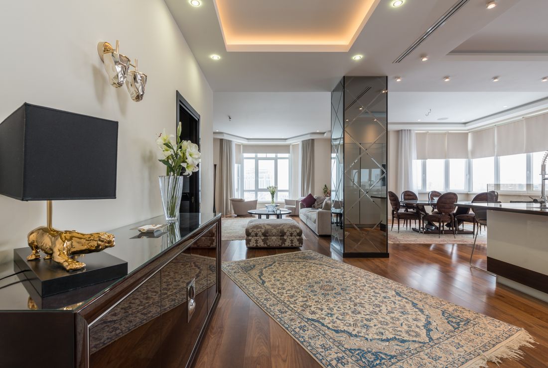 Finished apartment interior with timber flooring and recessed lighting